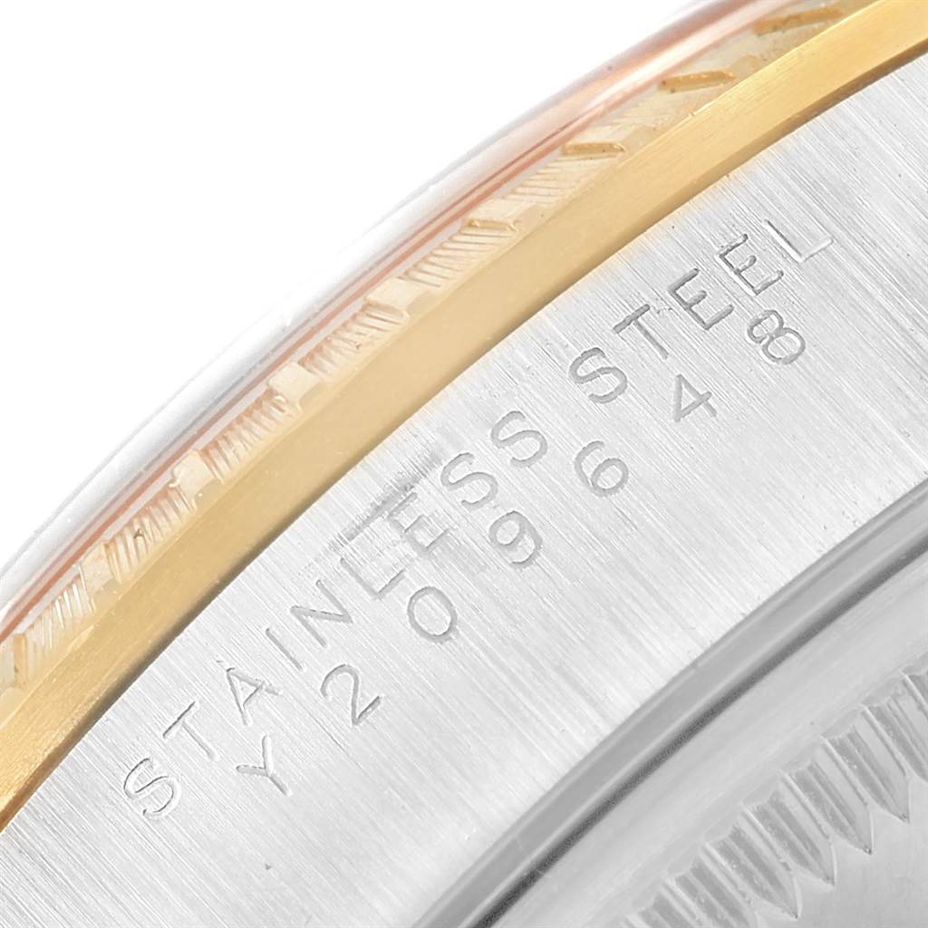 This image shows a close-up of the side case and the edge of the bezel of a Rolex Date 15223 Men's Steel and Gold (two tone) White Dial 15223 Men's Steel and Gold (two tone) White Dial model watch, highlighting the stainless steel marking.