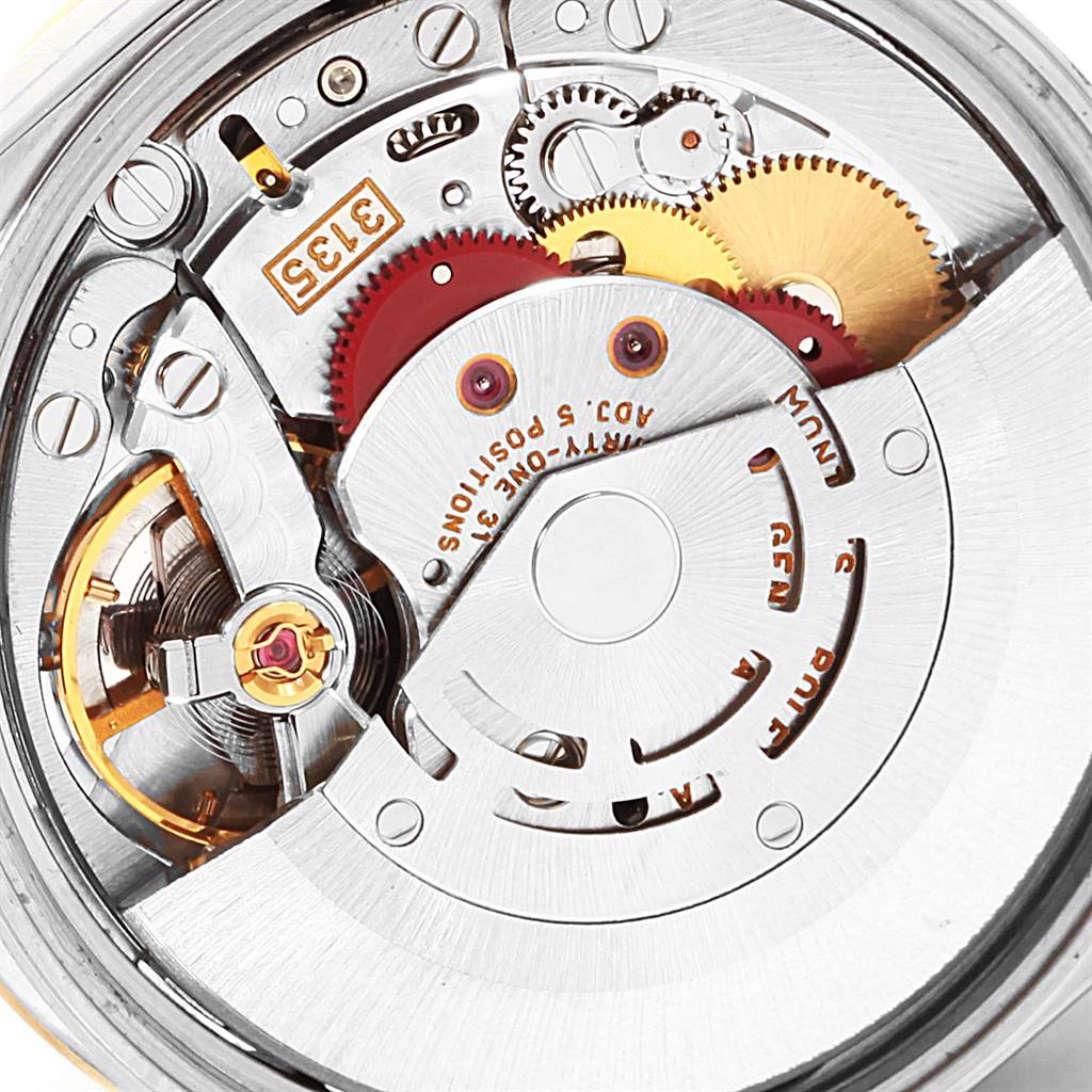 This image shows a close-up of the Rolex Date 15203 Men's Steel and Gold (two tone) Black Dial 15203 Men's Steel and Gold (two tone) Black Dial watch's movement, highlighting its gears and intricate mechanical parts.