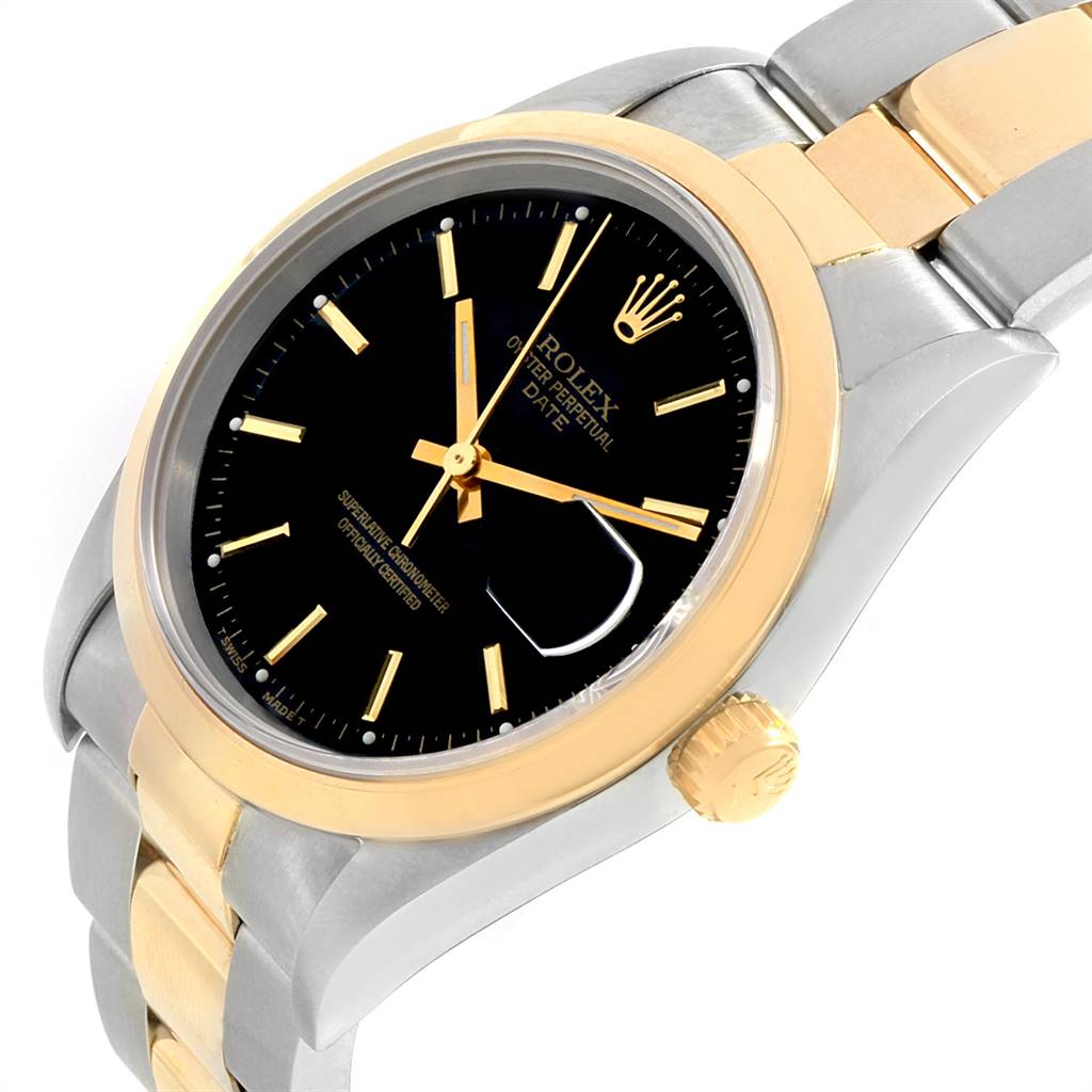 The image shows a close-up angle of the Rolex Date 15203 Men's Steel and Gold (two tone) Black Dial 15203 Men's Steel and Gold (two tone) Black Dial model watch focusing on the dial, bezel, crown, and part of the bracelet.