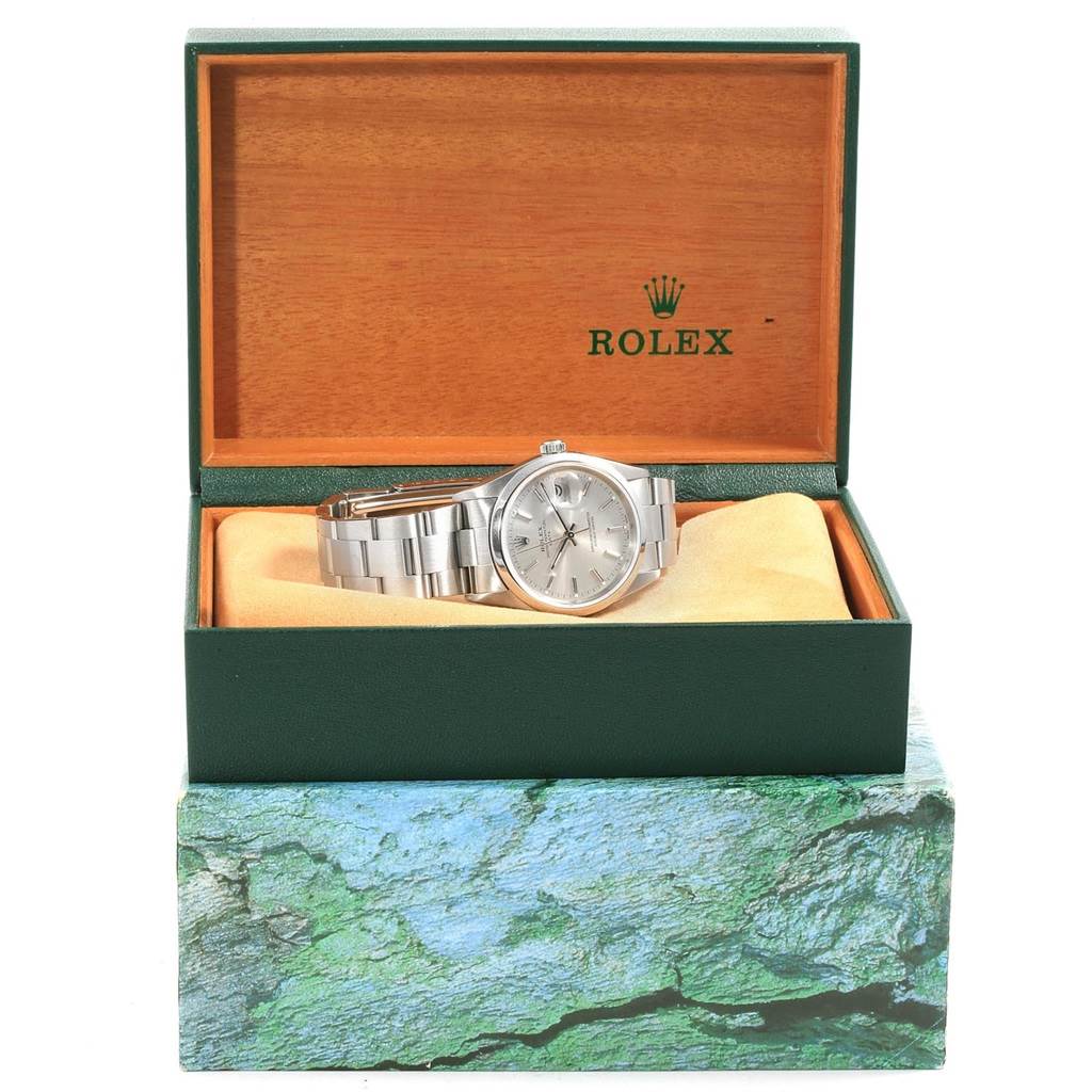 The Rolex Date 15200 Men's Stainless Steel Silver Dial 15200 Men's Stainless Steel Silver Dial model watch is displayed at an angle within its green and wooden presentation box.
