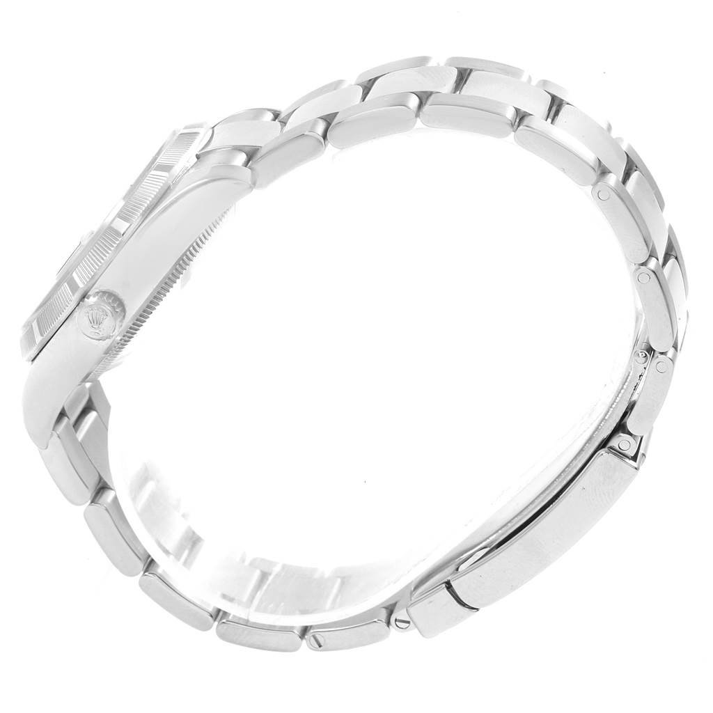 The image shows a side view of a Rolex Date 115210 Men's Stainless Steel Blue Dial 115210 Men's Stainless Steel Blue Dial model, displaying the case, crown, and stainless steel bracelet.