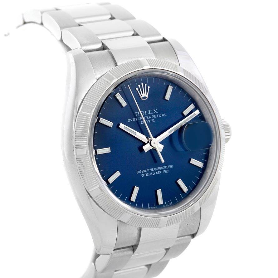 The image shows a Rolex Date 115210 Men's Stainless Steel Blue Dial 115210 Men's Stainless Steel Blue Dial model watch angled from the left, highlighting the face, bezel, and part of the bracelet.