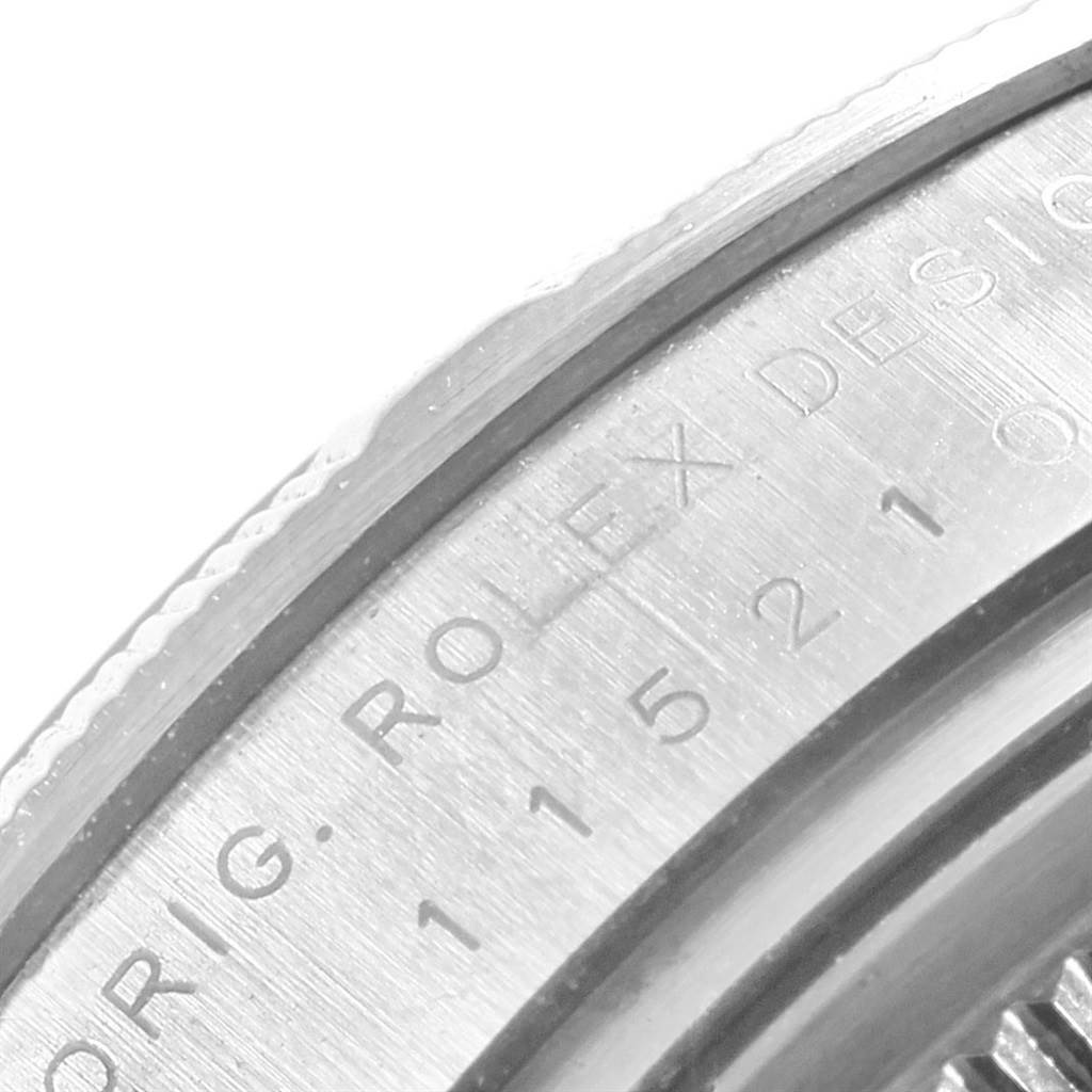 The image shows a close-up view of the engraved inner bezel of a Rolex Date 115210 Men's Stainless Steel Blue Dial 115210 Men's Stainless Steel Blue Dial model watch.