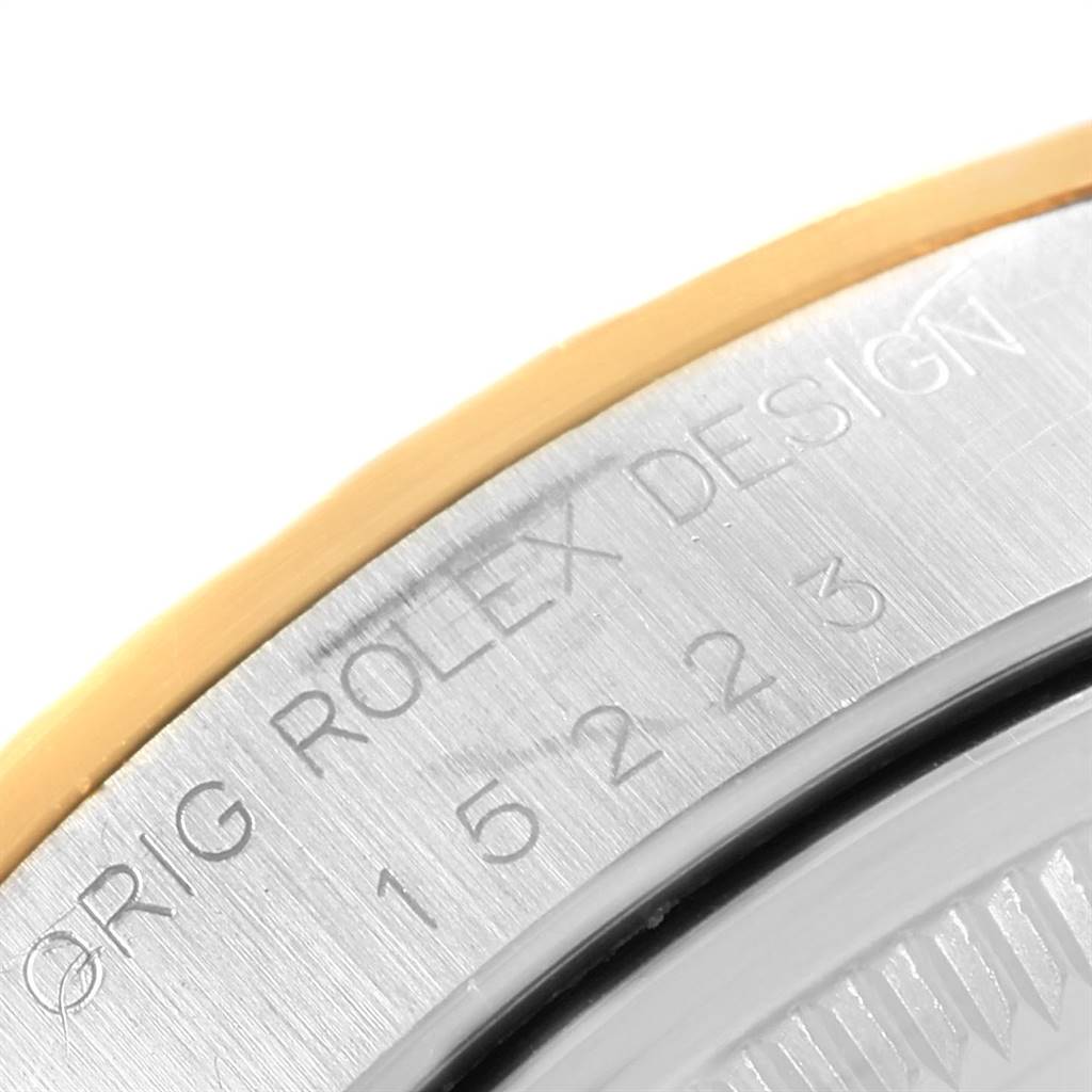 This close-up image shows the edge of the case back and part of the bezel of a Rolex Date 15223 Men's Steel and Gold (two tone) Champagne Dial 15223 Men's Steel and Gold (two tone) Champagne Dial model watch.