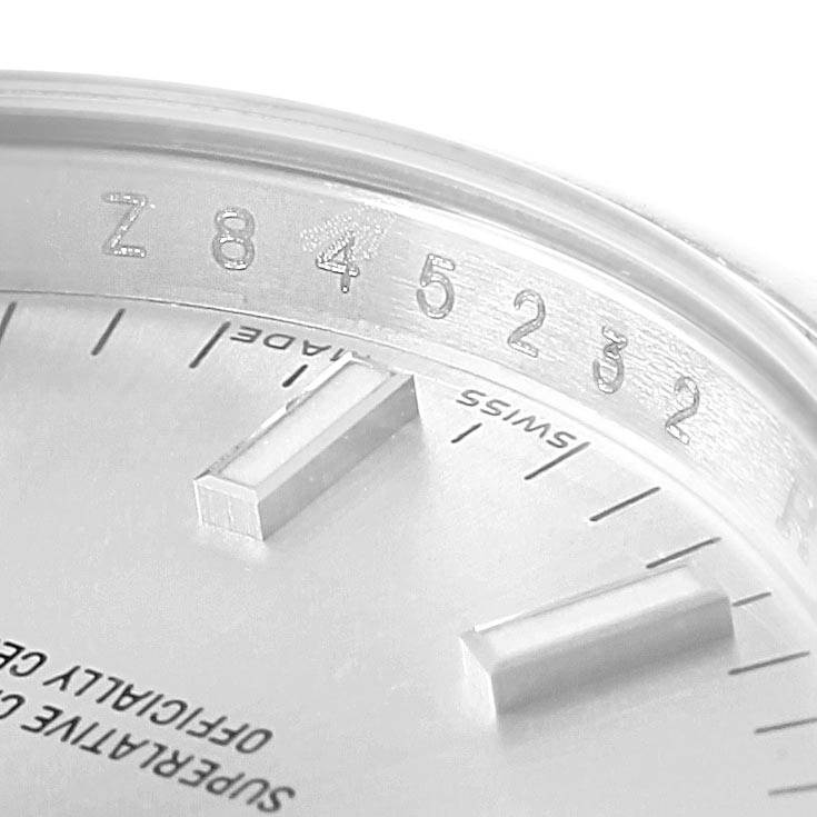 This close-up image shows the dial and part of the case edge of a Rolex Date 115200 Men's Stainless Steel Silver Dial 115200 Men's Stainless Steel Silver Dial model, highlighting the indices and serial number.