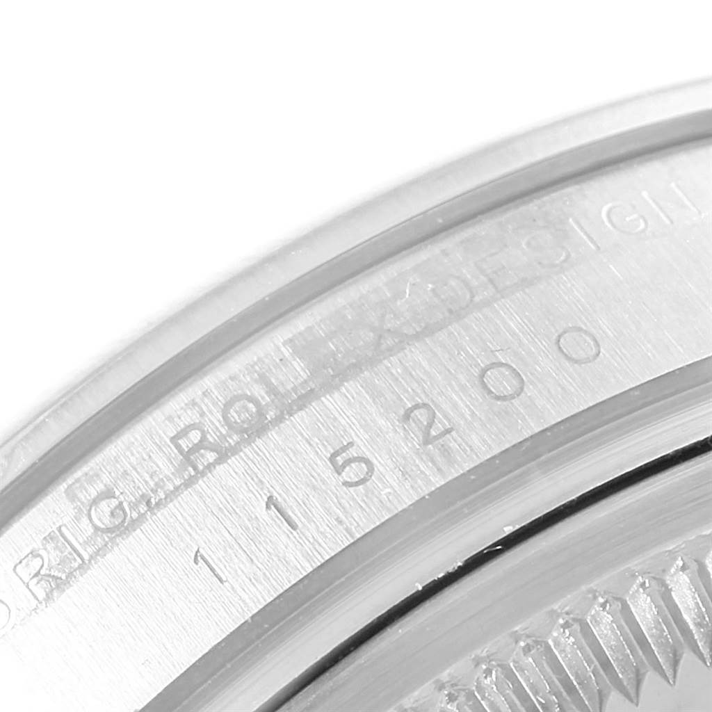 This image shows a close-up of the inner bezel and part of the casing of a Rolex Date 115200 Men's Stainless Steel Silver Dial 115200 Men's Stainless Steel Silver Dial model watch.
