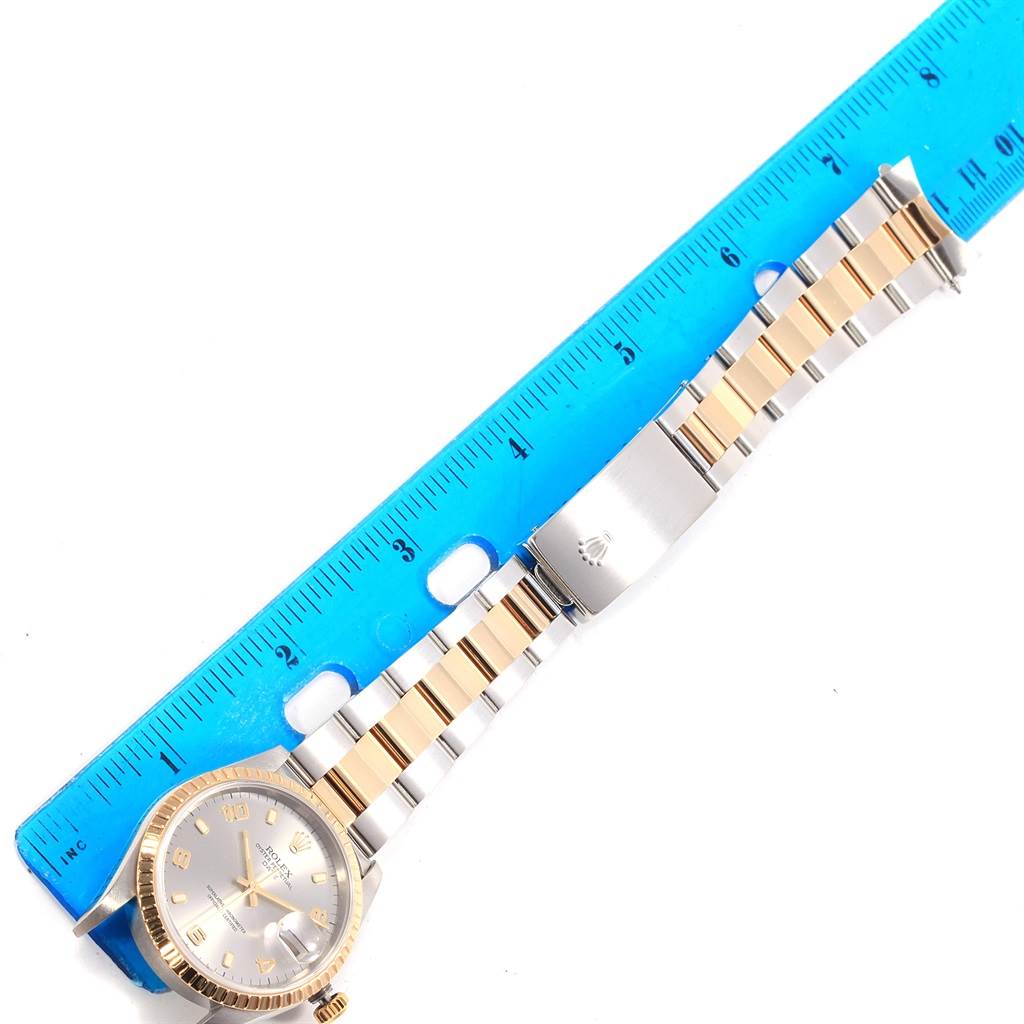 The image shows a Rolex Date 15223 Men's Steel and Gold (two tone) Grey Dial 15223 Men's Steel and Gold (two tone) Grey Dial watch laid flat with a ruler for measurement and exposing its full two-tone bracelet and clasp.