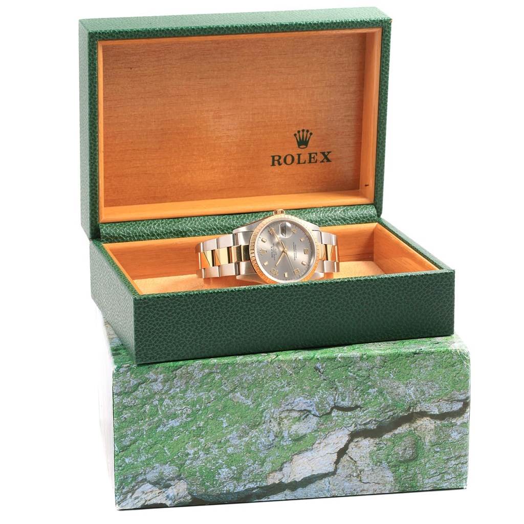 The Rolex Date 15223 Men's Steel and Gold (two tone) Grey Dial 15223 Men's Steel and Gold (two tone) Grey Dial watch is shown inside its green display box, viewed from a front angle.