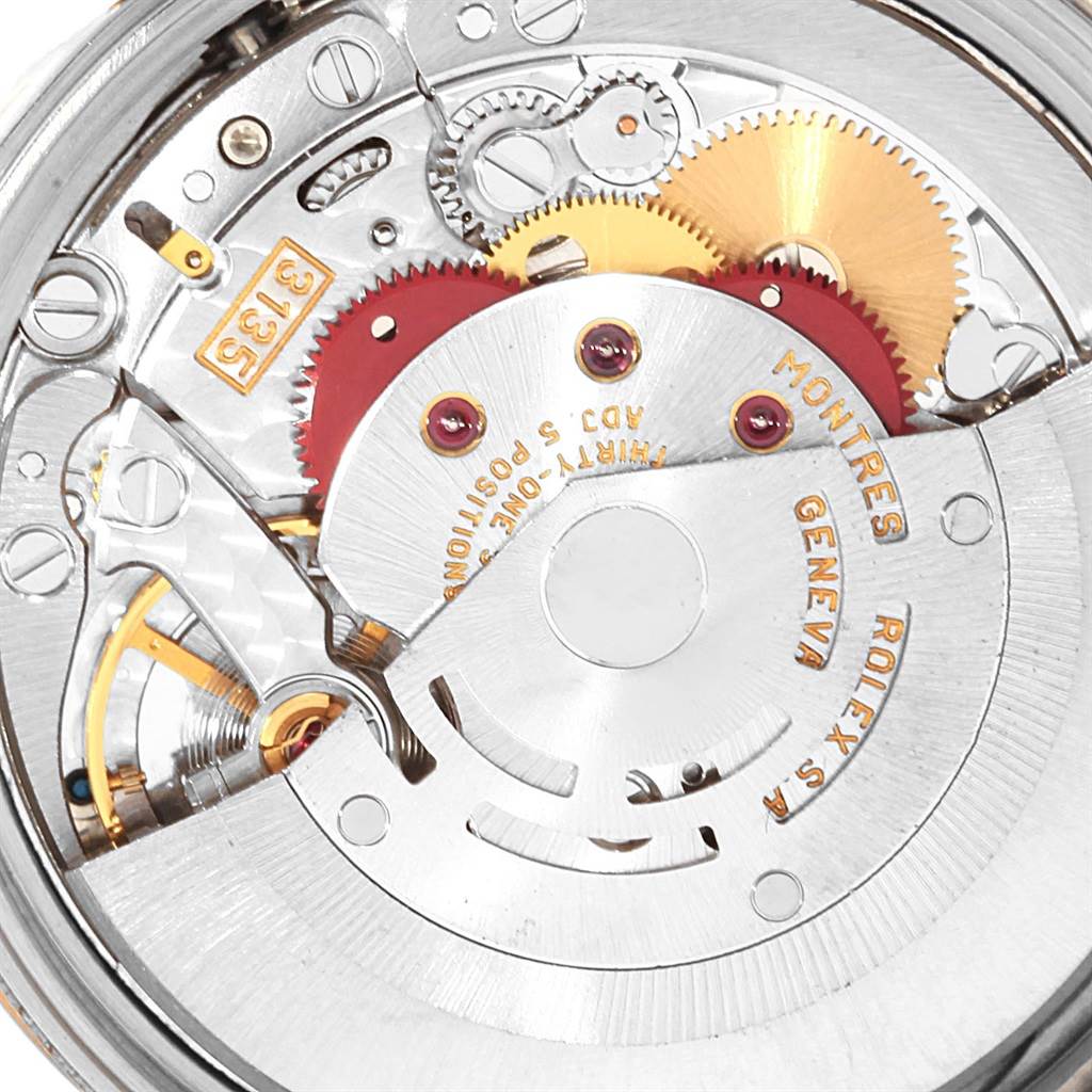 This is a close-up view of the Rolex Date 15223 Men's Steel and Gold (two tone) Grey Dial 15223 Men's Steel and Gold (two tone) Grey Dial model watch movement, showing gears and the rotor.