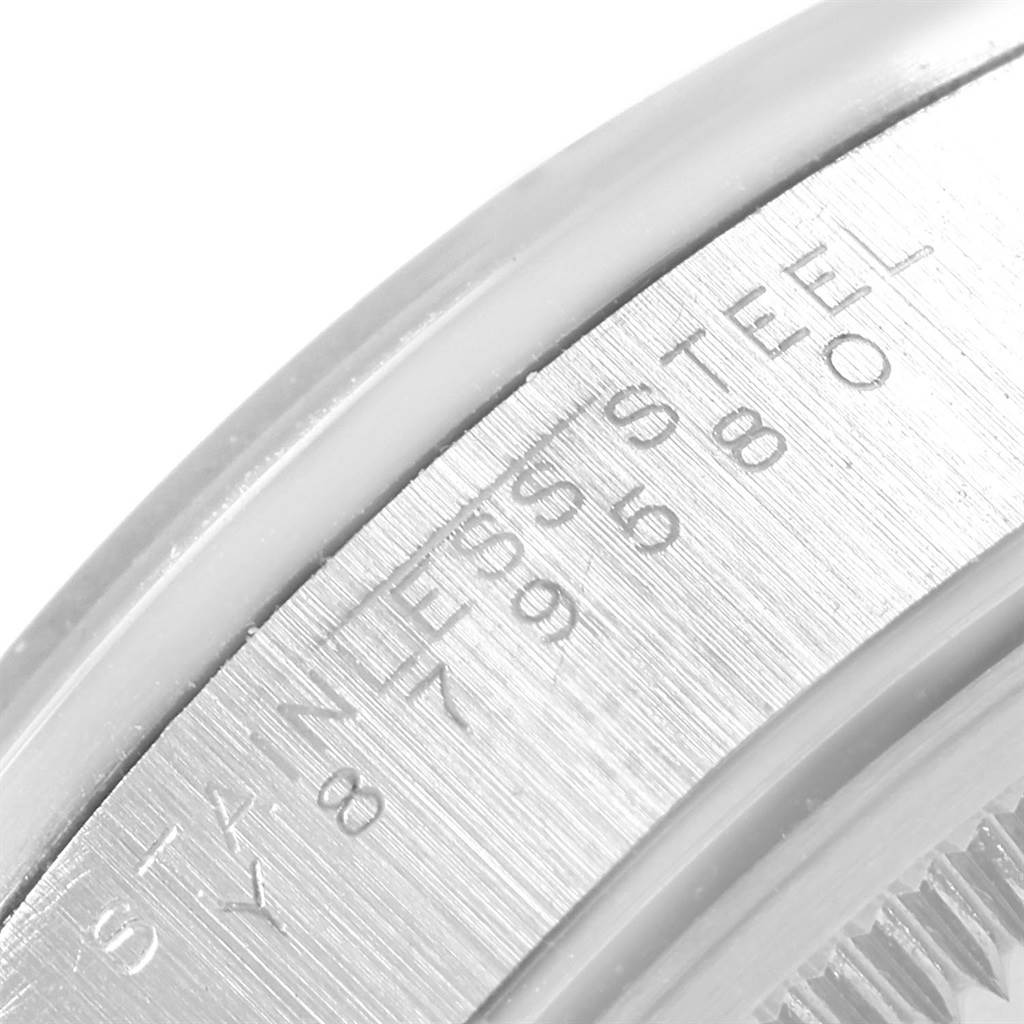 This image shows a close-up of the inner bezel or rehaut of a Rolex Date 15200 Men's Stainless Steel White Dial 15200 Men's Stainless Steel White Dial model watch, revealing part of its engraving.