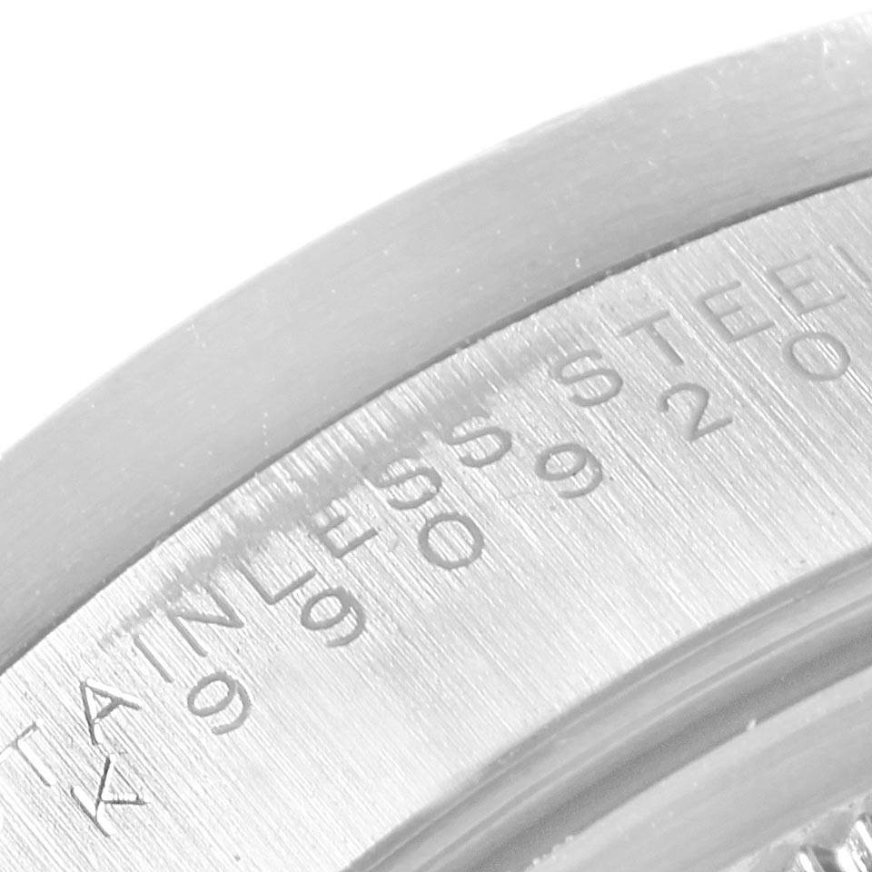 The image shows a close-up of the serial number engraving on the side of the Rolex Date 15210 Men's Stainless Steel Black Dial 15210 Men's Stainless Steel Black Dial watch’s case.