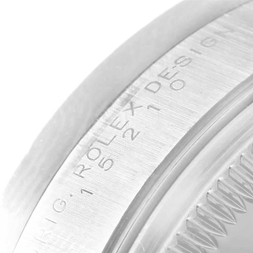 The image shows a close-up angle of the bezel and part of the crystal on a Rolex Date 15210 Men's Stainless Steel Black Dial 15210 Men's Stainless Steel Black Dial model watch.