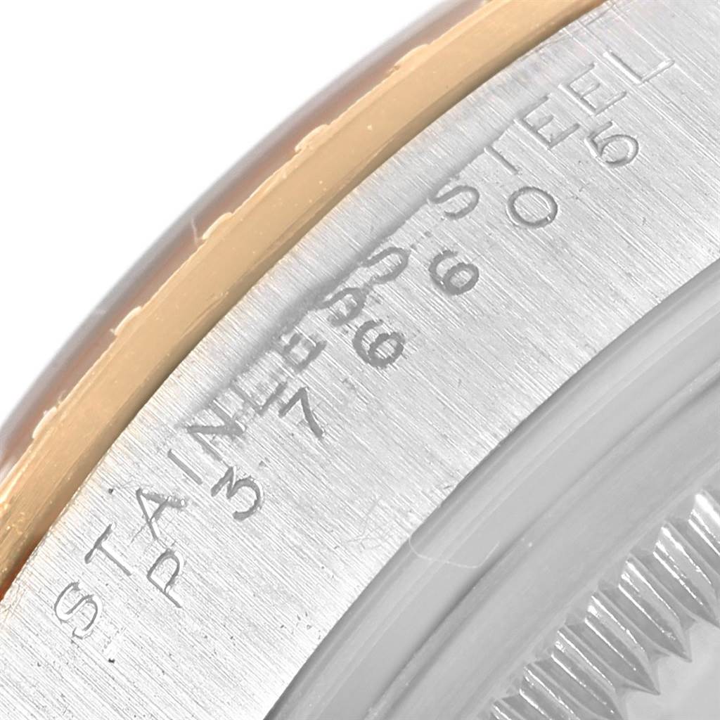 This image shows a close-up of the side and back of a Rolex Date 15223 Men's Steel and Gold (two tone) Silver Dial 15223 Men's Steel and Gold (two tone) Silver Dial watch, highlighting the "STAINLESS STEEL" engraving.