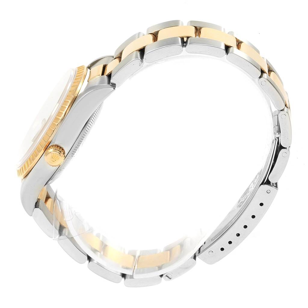 The image shows the side view of a Rolex Date 15223 Men's Steel and Gold (two tone) Silver Dial 15223 Men's Steel and Gold (two tone) Silver Dial model watch, highlighting the two-tone bracelet and crown.