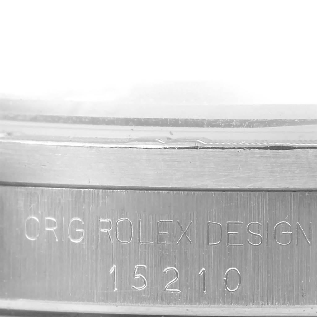 This close-up image shows the etched serial and model numbers on the side of the case for the Rolex Date 15210 Men's Stainless Steel Silver Dial 15210 Men's Stainless Steel Silver Dial watch.