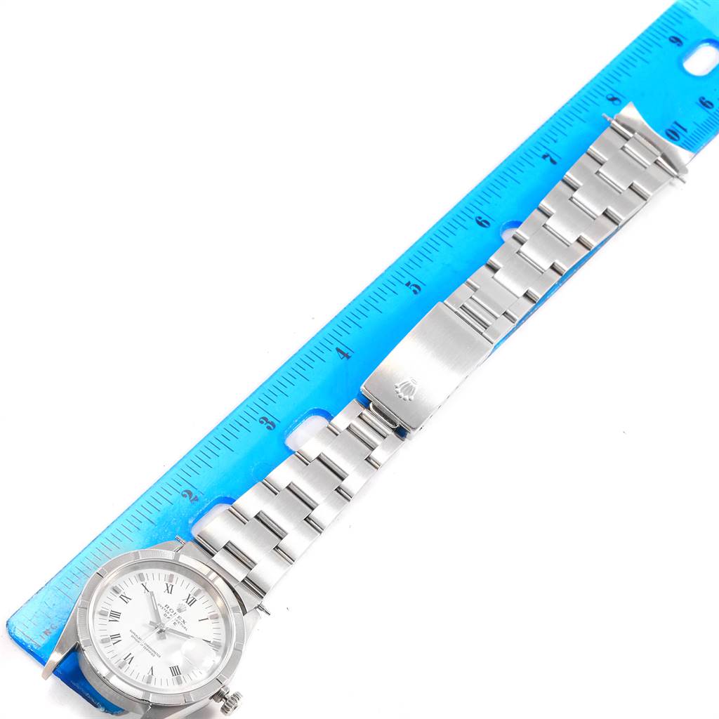 This image shows a Rolex Date 15210 Men's Stainless Steel White Dial 15210 Men's Stainless Steel White Dial model watch lying flat with a blue ruler for size reference.