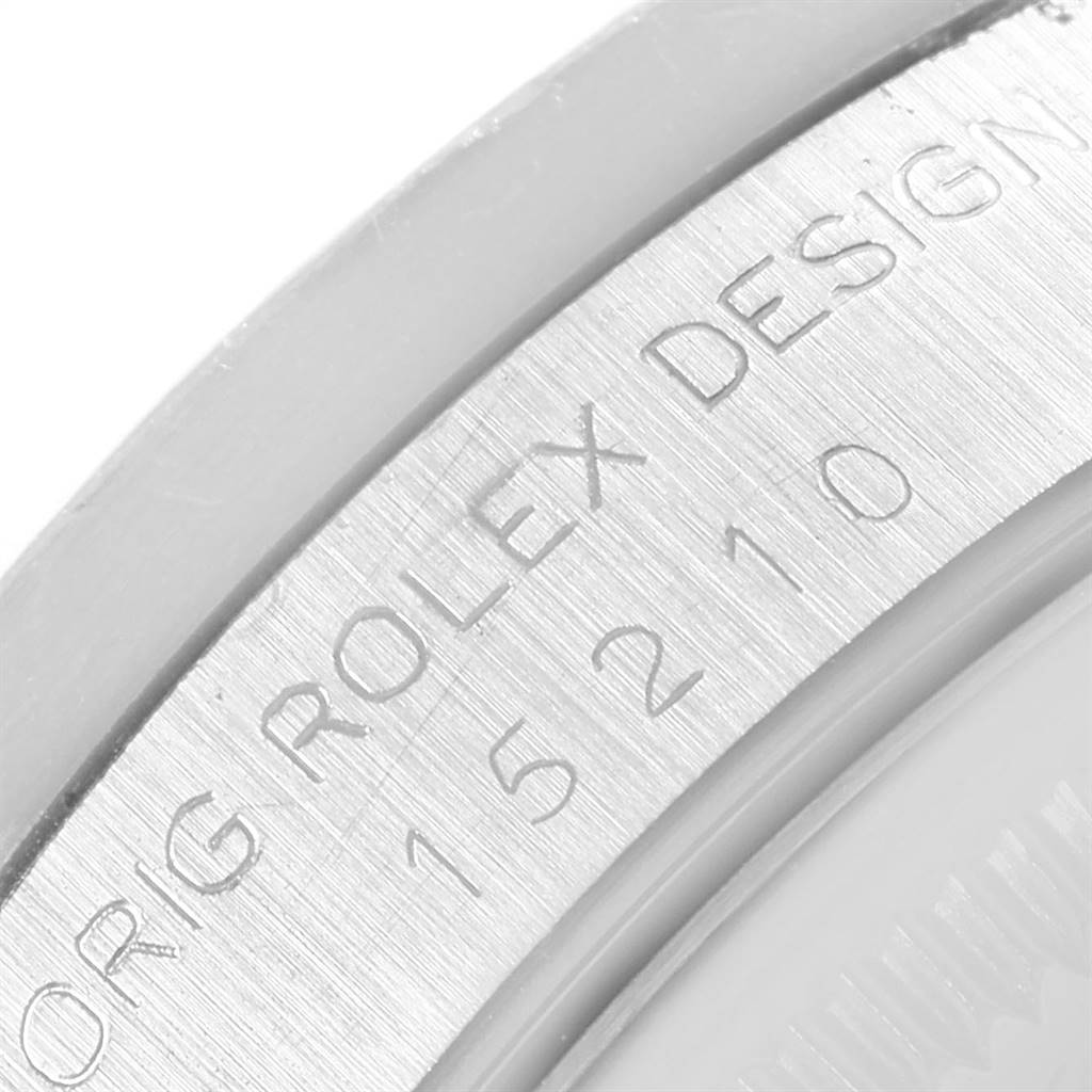 This image shows a close-up of the engraved case edge of a Rolex Date 15210 Men's Stainless Steel White Dial 15210 Men's Stainless Steel White Dial model.