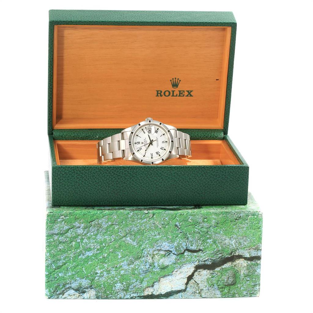 This Rolex Date 15210 Men's Stainless Steel White Dial 15210 Men's Stainless Steel White Dial model watch is shown front-facing, displayed inside an opened green and wood-tone Rolex box.