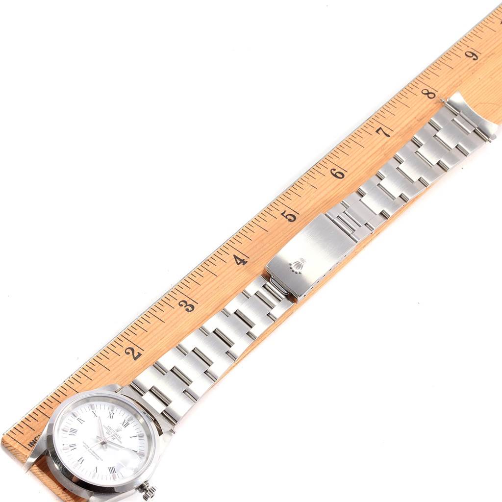 This image shows a Rolex Date 15200 Men's Stainless Steel White Dial 15200 Men's Stainless Steel White Dial model watch at a top-down angle, with the watch face, bracelet, and clasp displayed along a ruler.