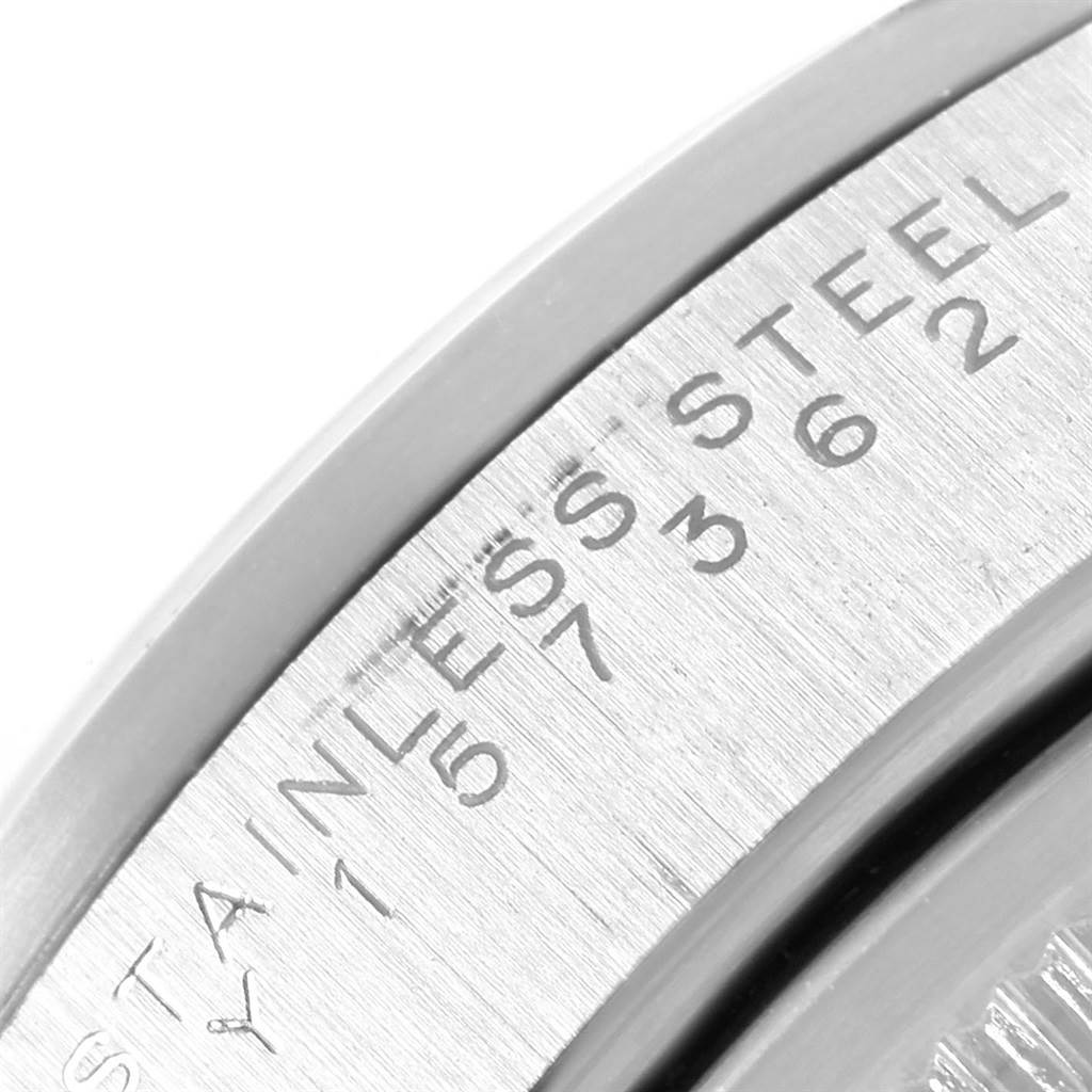 Close-up of the side engraving on a Date model Rolex watch, showing "STAINLESS STEEL" and some numbers.