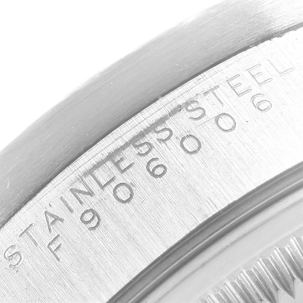This close-up image shows the serial number and "STAINLESS STEEL" inscription on the case back edge of a Rolex Date 15210 Men's Stainless Steel Silver Dial 15210 Men's Stainless Steel Silver Dial model watch.