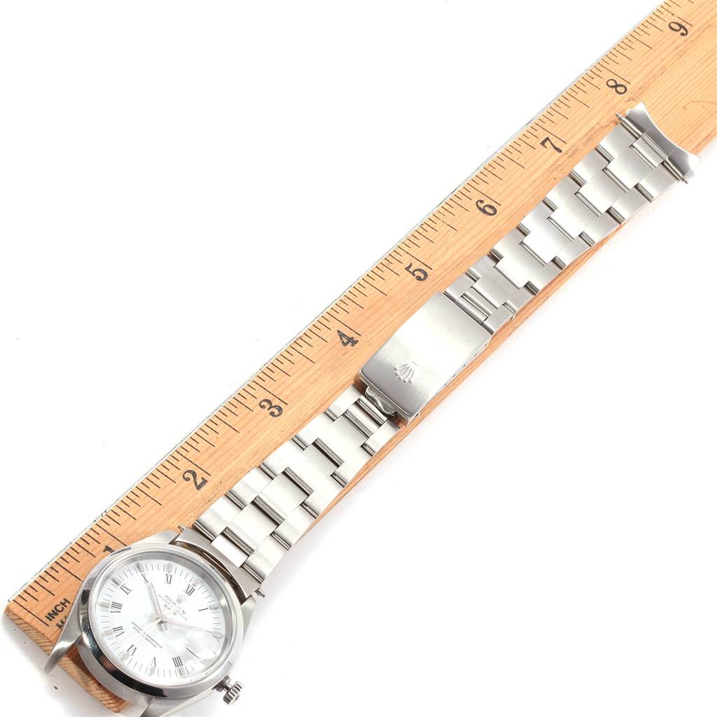 The Rolex Date 15200 Men's Stainless Steel White Dial 15200 Men's Stainless Steel White Dial model watch is shown from an overhead angle, highlighting its face and bracelet, measured against a ruler.