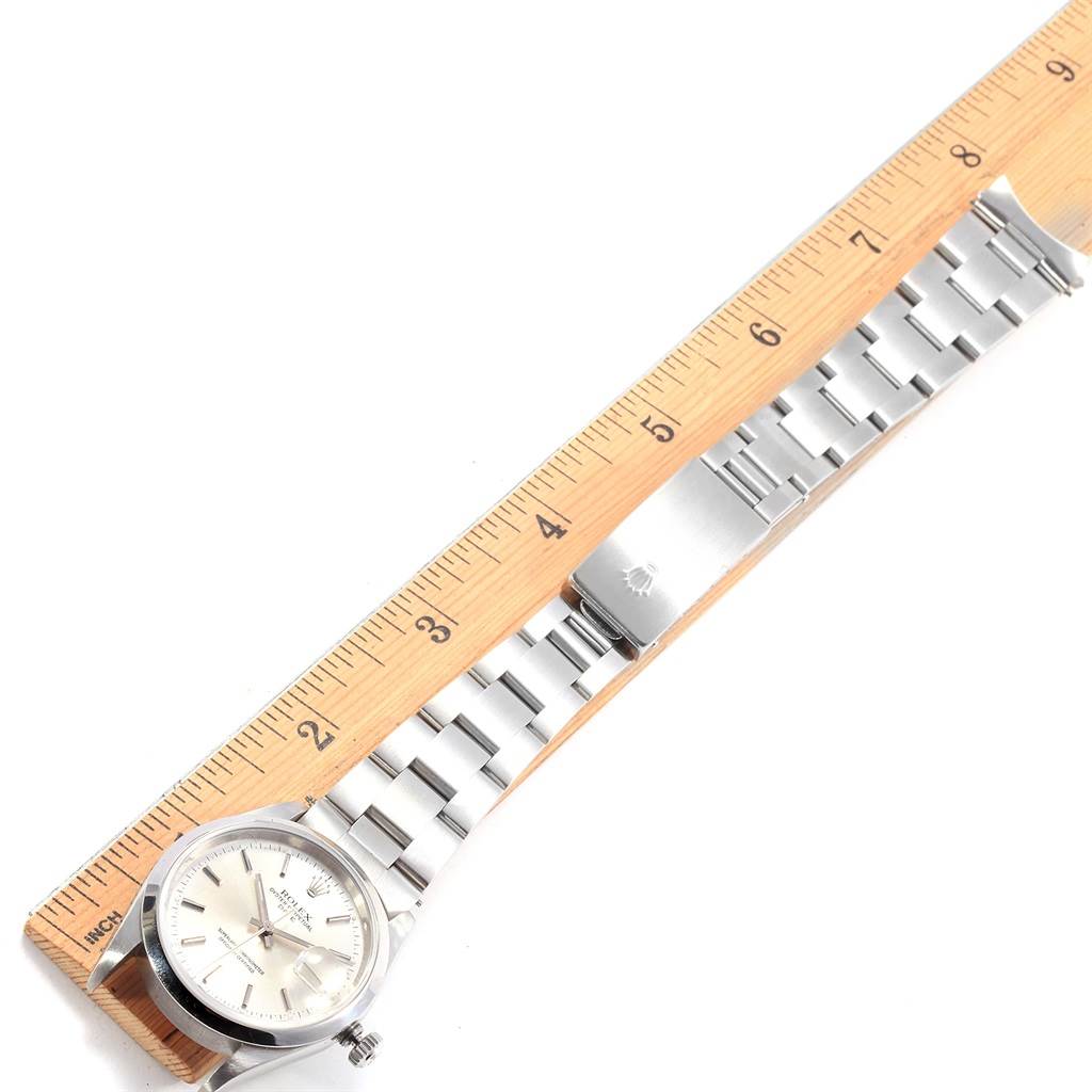 The image shows the face and the bracelet of a Rolex Date 15200 Men's Stainless Steel Silver Dial 15200 Men's Stainless Steel Silver Dial model watch placed alongside a ruler for scale.