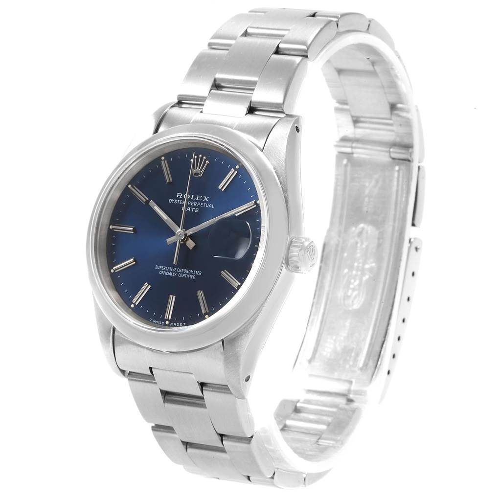 The image shows a Rolex Oyster Perpetual Date watch at a slight angle, highlighting its blue dial, case, and metal bracelet.