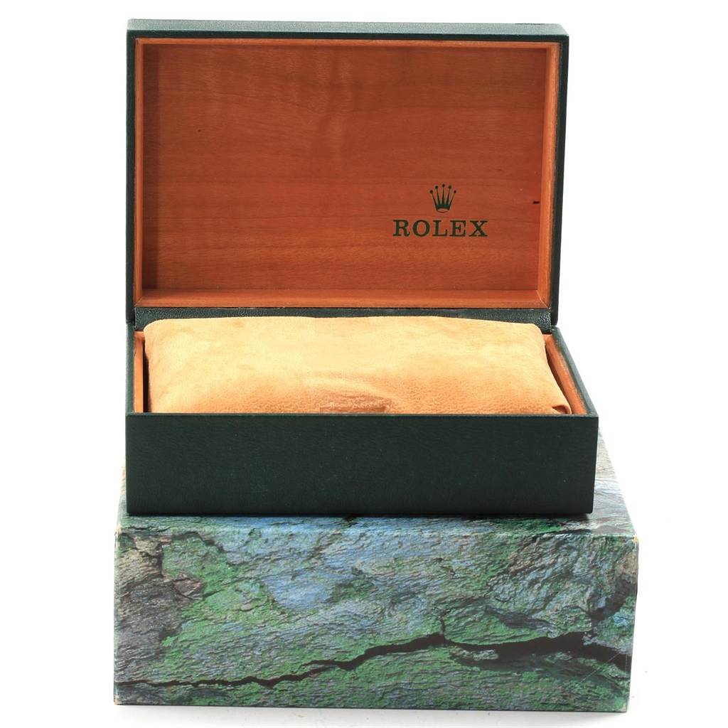 The image shows an open Rolex box for the Date model watch, with a cushion inside but the watch is not visible.