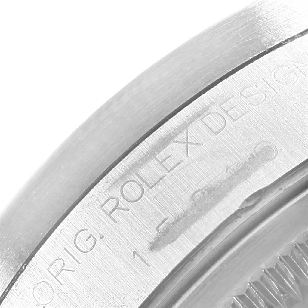 This image shows a close-up of the case side of a Rolex Date 15210 Men's Stainless Steel Black Dial 15210 Men's Stainless Steel Black Dial model, featuring the engraved brand name.