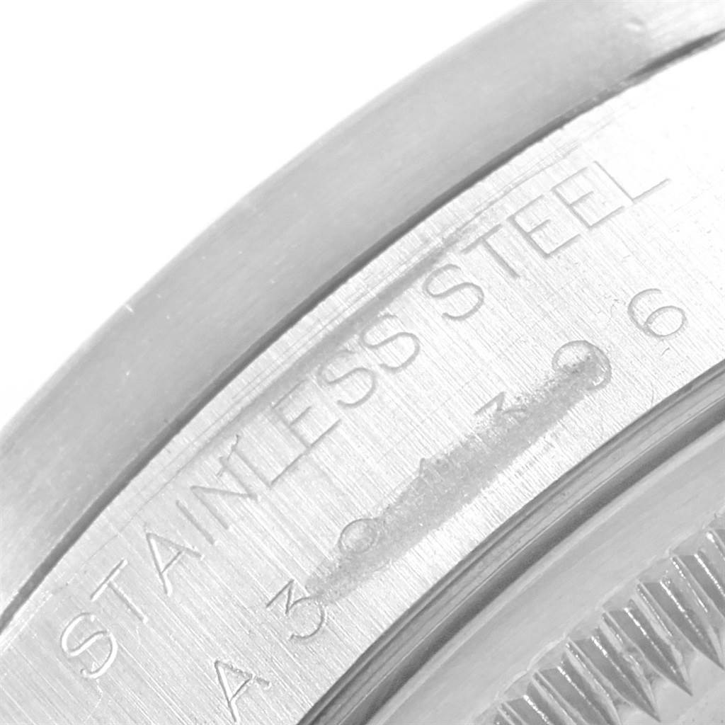 The image shows a close-up of the stainless steel caseback and part of the serial number on the Rolex Date 15210 Men's Stainless Steel Black Dial 15210 Men's Stainless Steel Black Dial model watch.