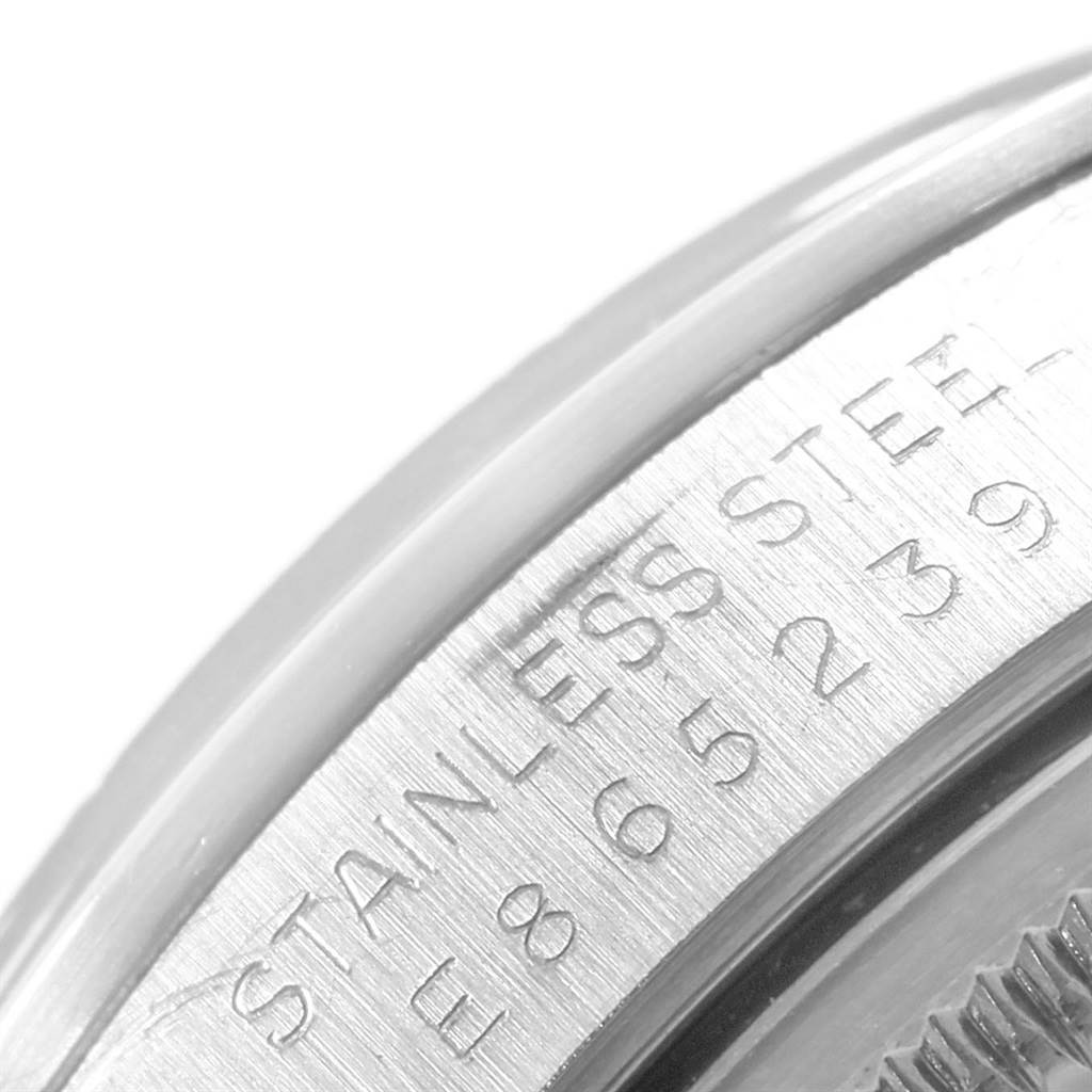 This close-up image of a Rolex Date 15200 Men's Stainless Steel Black Dial 15200 Men's Stainless Steel Black Dial model watch shows part of the bezel with engraved serial numbers.