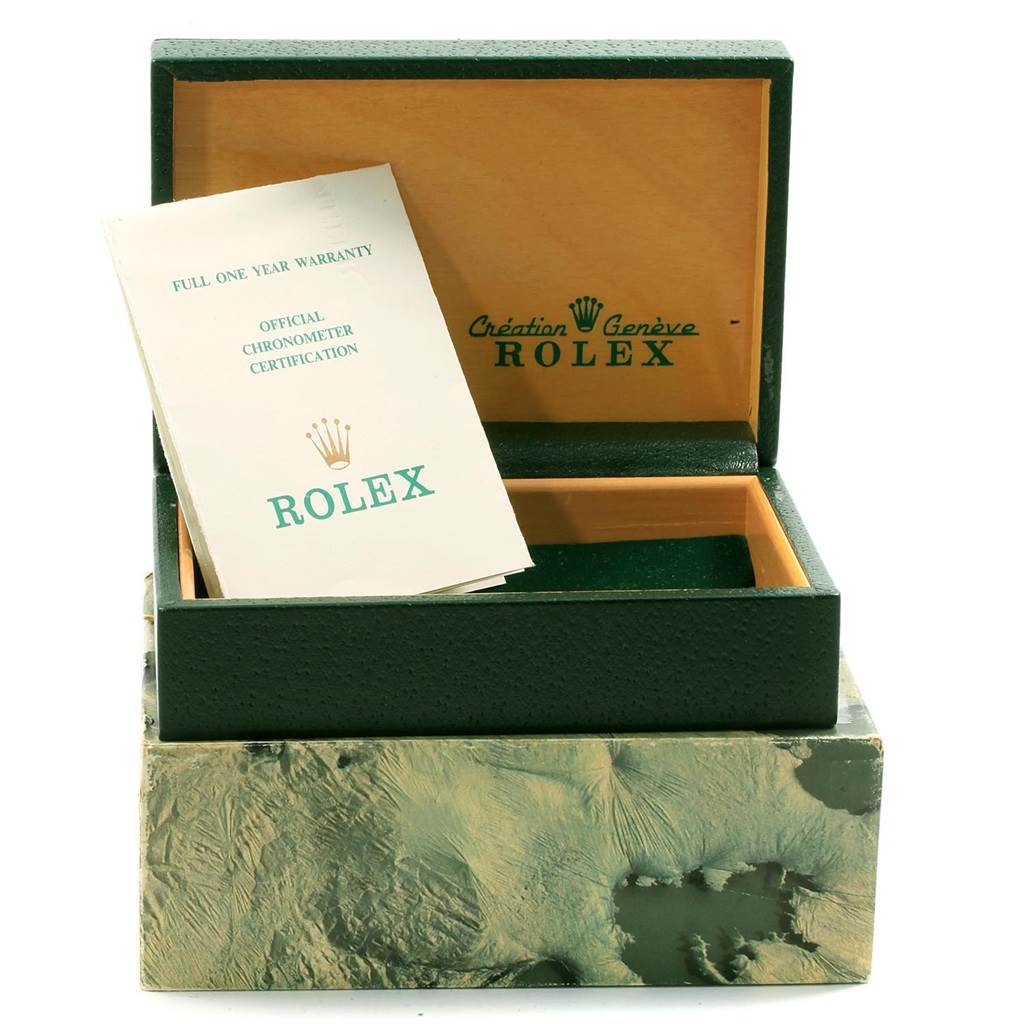 The image shows an open Rolex watch box for the Date model, along with warranty and certification papers.
