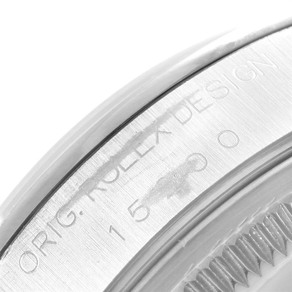 The image shows a close-up of the engraved bezel on a Rolex Date 15200 Men's Stainless Steel White Dial 15200 Men's Stainless Steel White Dial model watch.