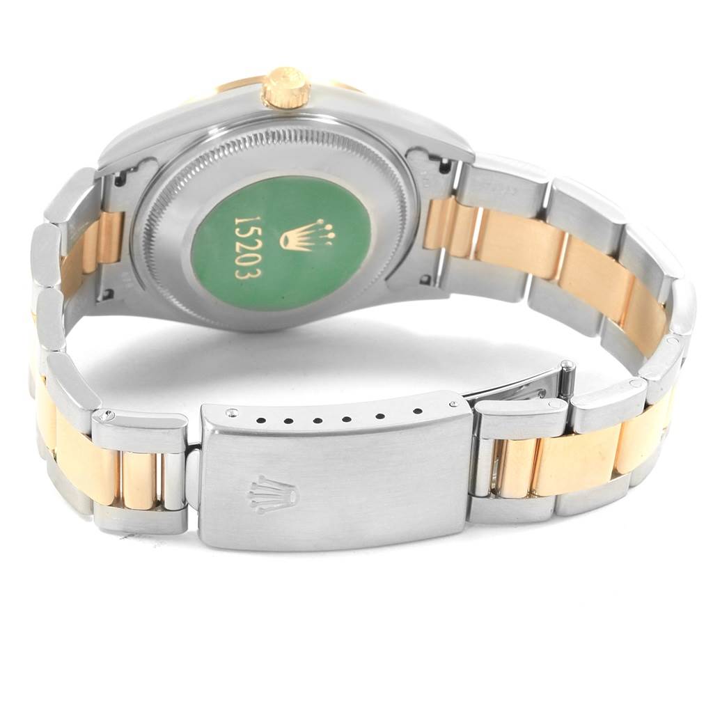 This image shows the back case and bracelet of a Rolex Date 15203 Men's Steel and Gold (two tone) Champagne Dial 15203 Men's Steel and Gold (two tone) Champagne Dial model watch, emphasizing the two-tone bracelet and the clasp.