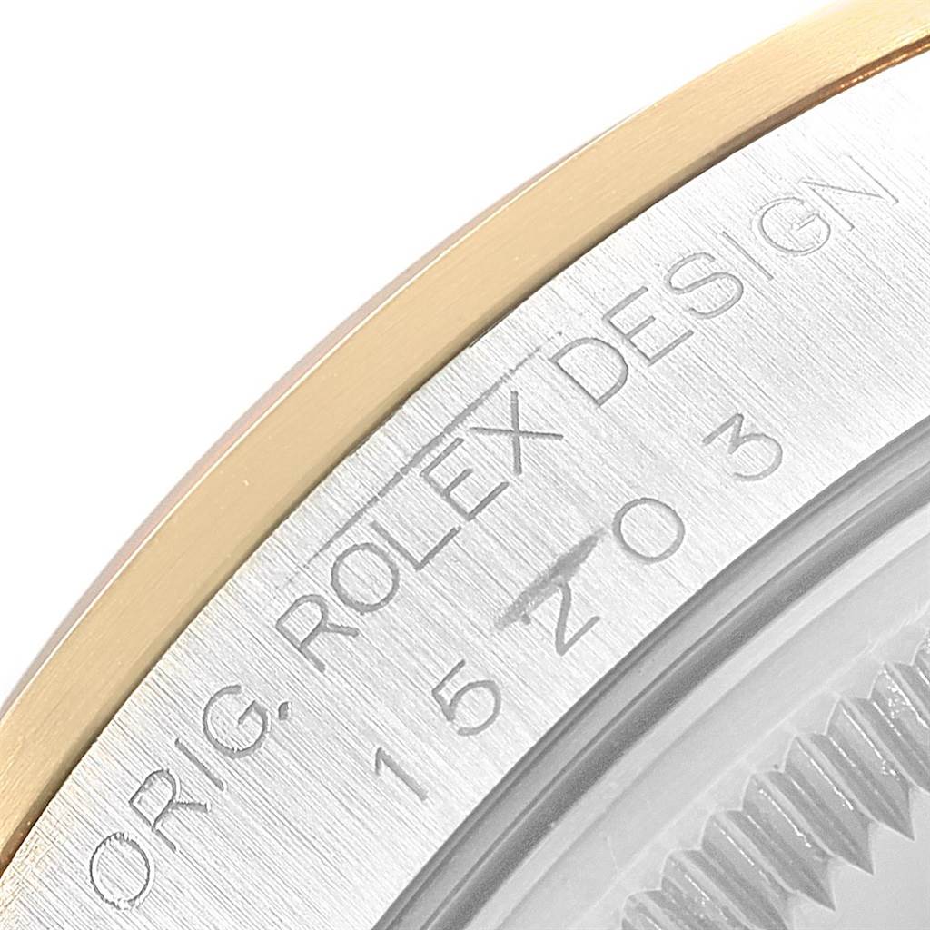 The image shows a close-up of the bezel and case edge of a Rolex Date 15203 Men's Steel and Gold (two tone) Champagne Dial 15203 Men's Steel and Gold (two tone) Champagne Dial model, revealing the model number and "ROLEX DESIGN" engraving.