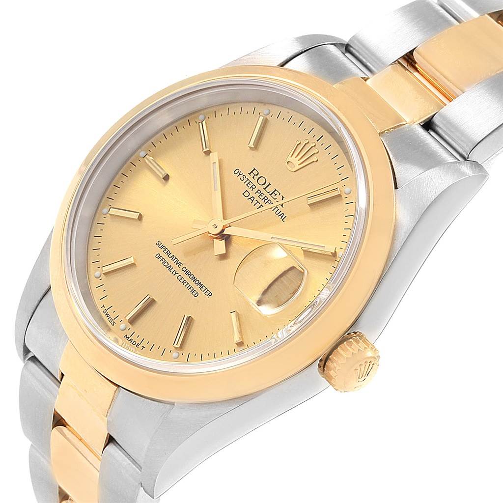 This image shows a close-up of the Rolex Date 15203 Men's Steel and Gold (two tone) Champagne Dial 15203 Men's Steel and Gold (two tone) Champagne Dial model watch from an angled top view featuring its dial, crown, and part of the bracelet.