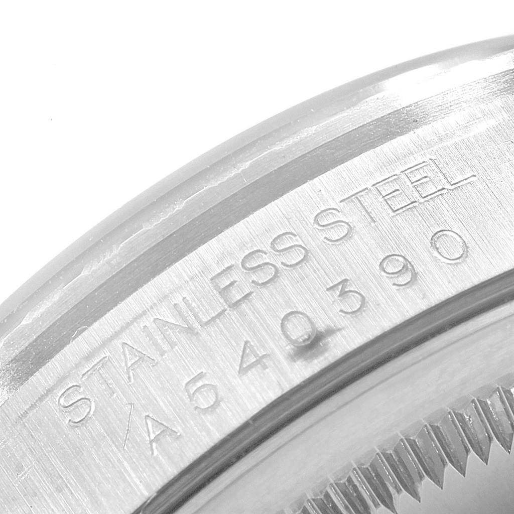The image shows a close-up of the stainless steel bezel with engraving details on a Rolex Date 16220 Men's Stainless Steel Silver Dial 16220 Men's Stainless Steel Silver Dial model watch.