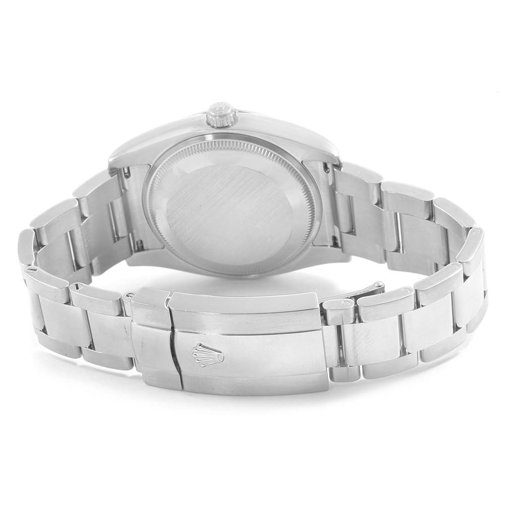 The image shows the back case and bracelet of a Rolex Date 115234 Men's Stainless Steel Blue Dial 115234 Men's Stainless Steel Blue Dial model watch from a rear angle.