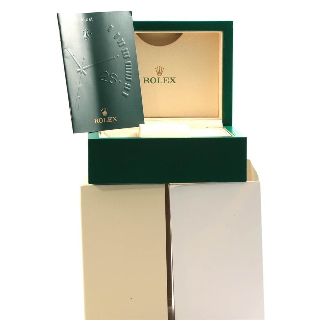The image shows an open green and beige Rolex box for the Date model, along with a matching booklet.