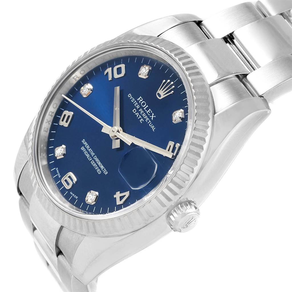 This is a close-up angled view of a Rolex Date 115234 Men's Stainless Steel Blue Dial 115234 Men's Stainless Steel Blue Dial watch showing its blue dial, fluted bezel, and stainless steel bracelet.