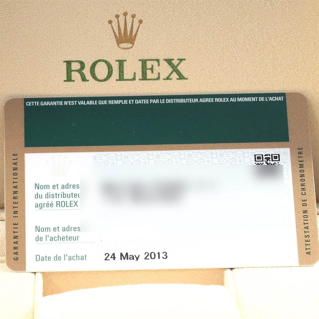 The image shows a Rolex warranty card for a Date model, taken from a top-down angle inside a Rolex box.