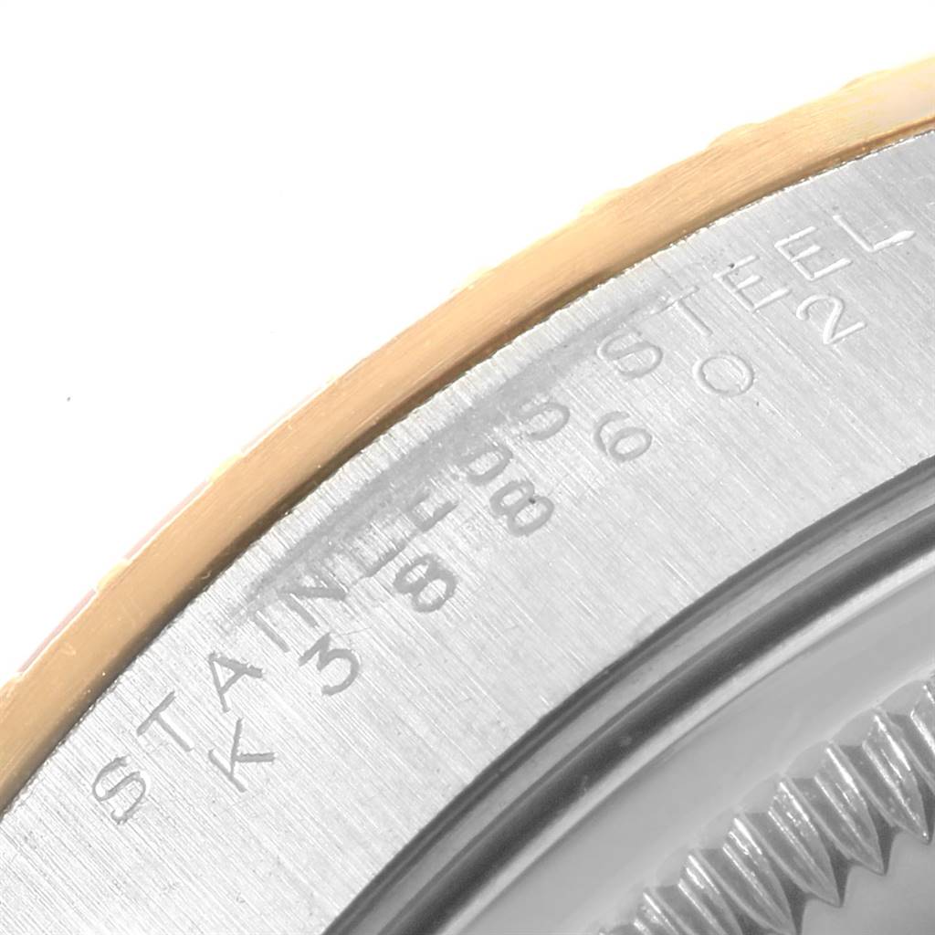 The image shows a close-up angle of the bezel and engraved markings on the case of a Rolex Date 15223 Men's Steel and Gold (two tone) White Dial 15223 Men's Steel and Gold (two tone) White Dial model watch.