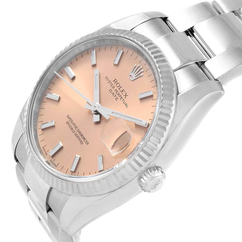 This Rolex Date 115234 Stainless Steel Pink Dial 115234 Stainless Steel Pink Dial model watch is shown at an angle displaying the dial, bezel, crown, and part of the bracelet.