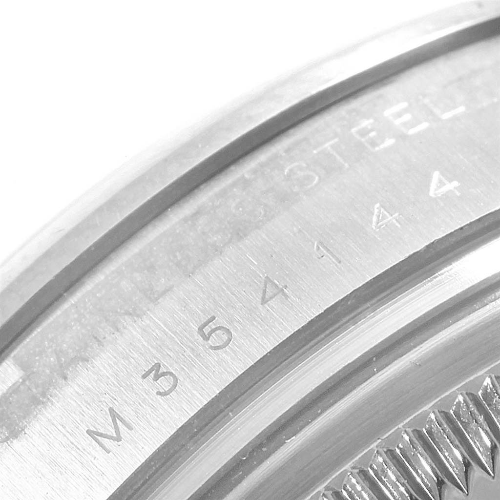 This image shows a close-up view of the stainless steel case back with serial number engraving on a Rolex Date 115200 Men's Stainless Steel Black Dial 115200 Men's Stainless Steel Black Dial model watch.