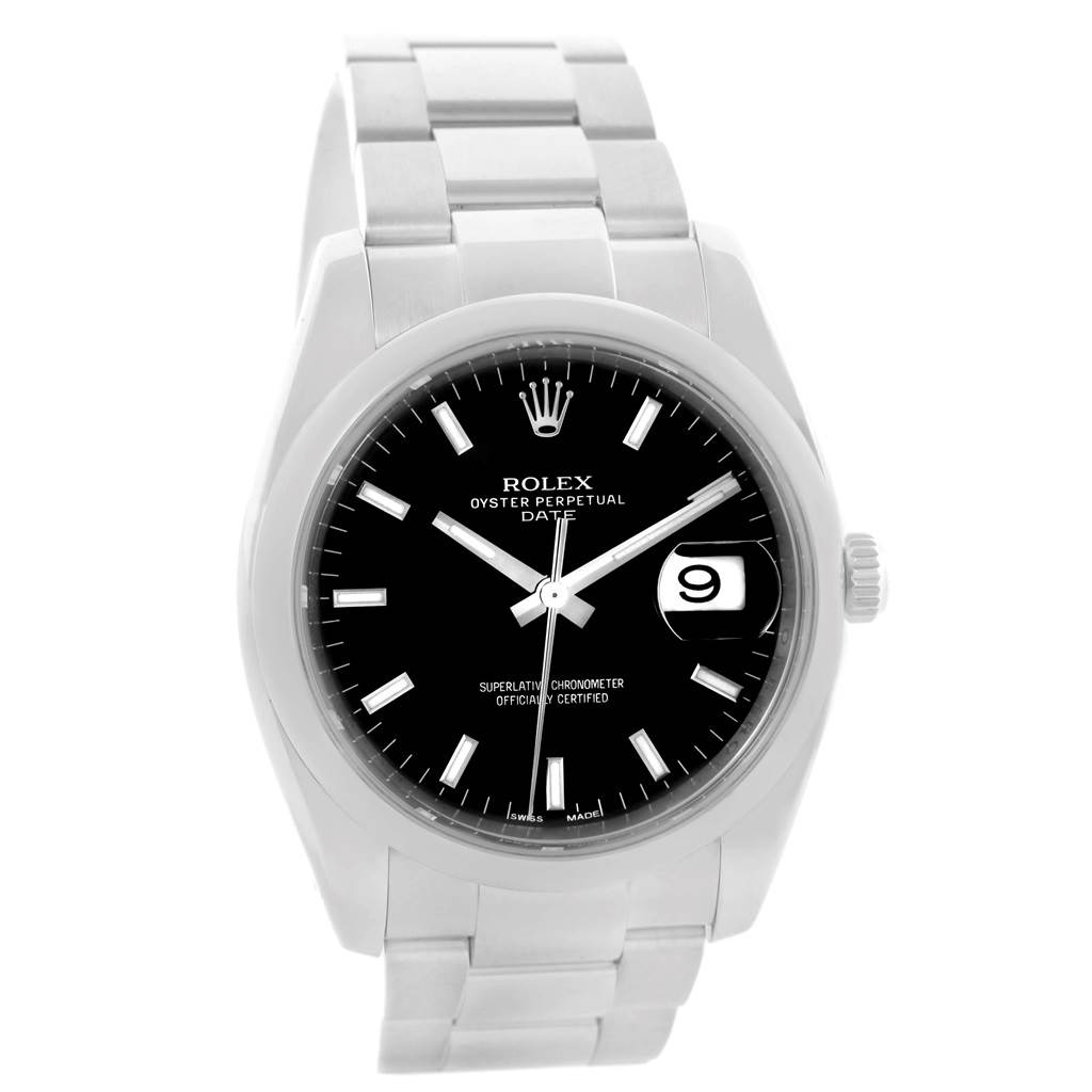 The image displays a front view of a Rolex Date 115200 Men's Stainless Steel Black Dial 115200 Men's Stainless Steel Black Dial watch, showing the black dial, hour markers, and part of the bracelet.