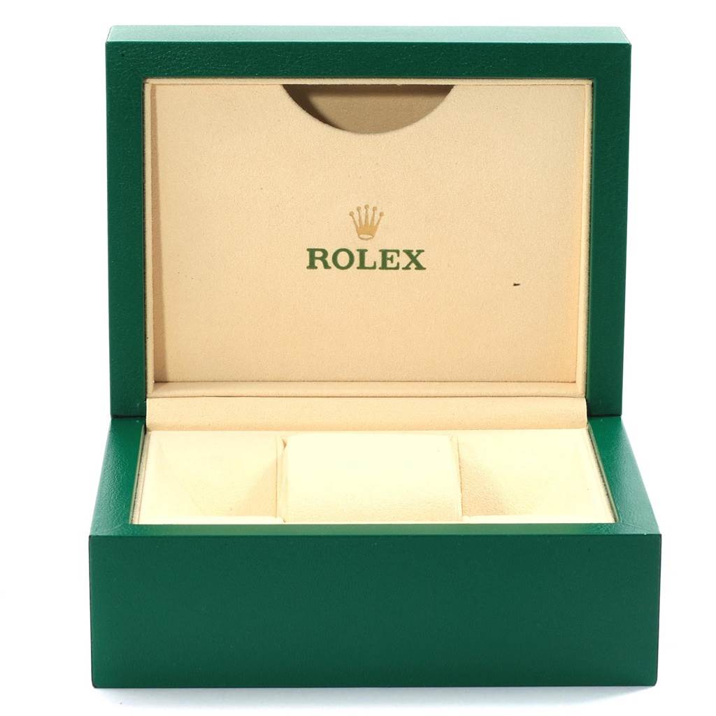 The image shows an open Rolex Date 115200 Men's Stainless Steel Black Dial 115200 Men's Stainless Steel Black Dial model watch box with green exterior and beige interior.