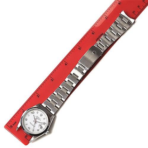 The image shows a Rolex Date 15200 Men's Stainless Steel White Dial 15200 Men's Stainless Steel White Dial model watch laid flat, with the entire face, bracelet, and clasp visible alongside a red ruler.