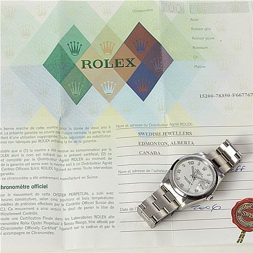 The image shows a Rolex Date 15200 Men's Stainless Steel White Dial 15200 Men's Stainless Steel White Dial model watch placed on top of its official certificates and documentation.