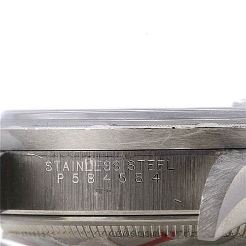 This image shows a close-up view of the case side of a Rolex Date 15210 Men's Stainless Steel Black Dial 15210 Men's Stainless Steel Black Dial model watch, highlighting the serial number and "STAINLESS STEEL" engraving.